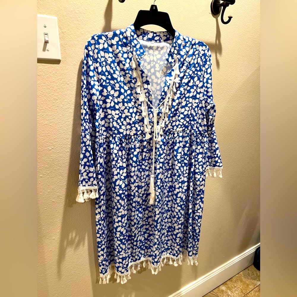 Blue dress with white tassel trim. Never worn.